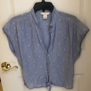 Blue, sleeveless top with small white accents